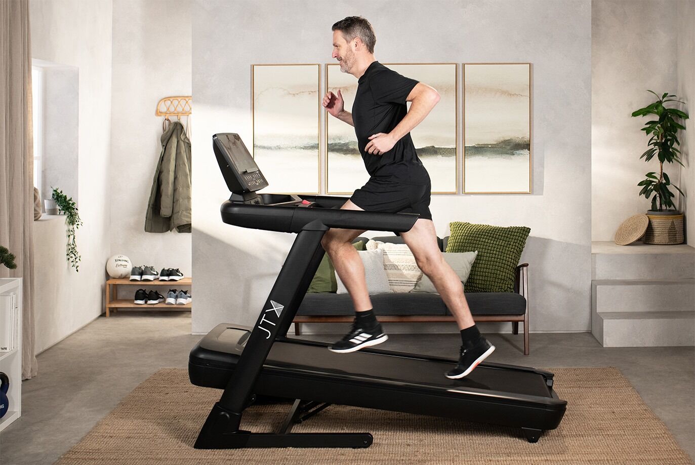 Man running on incline on the JTX Sprint-8 Pro treadmill