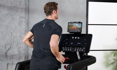 A man using the Zwift app while on a JTX Fitness running machine